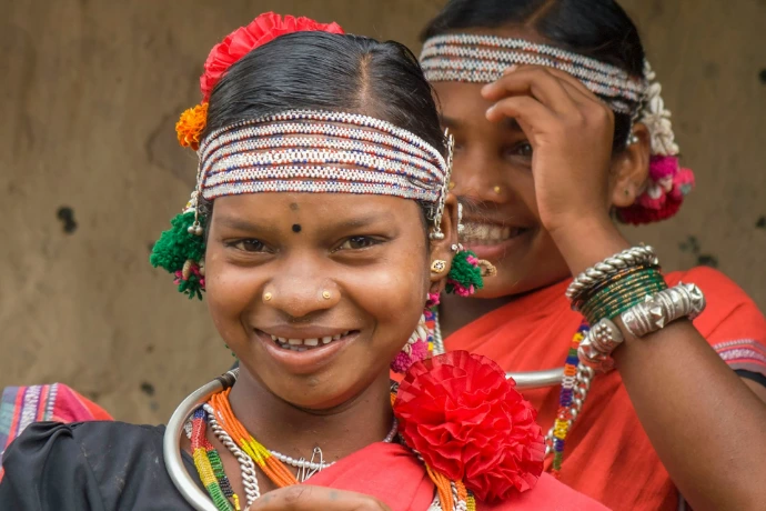 Two smiling girls in traditional attire